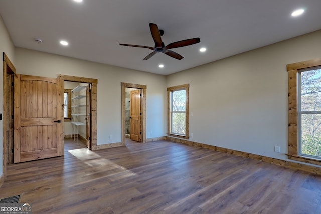 unfurnished bedroom with dark hardwood / wood-style floors, ceiling fan, and ensuite bathroom