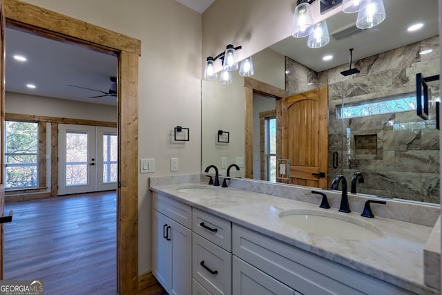 bathroom with a shower with door, vanity, hardwood / wood-style flooring, and ceiling fan