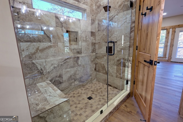 bathroom featuring walk in shower and hardwood / wood-style flooring