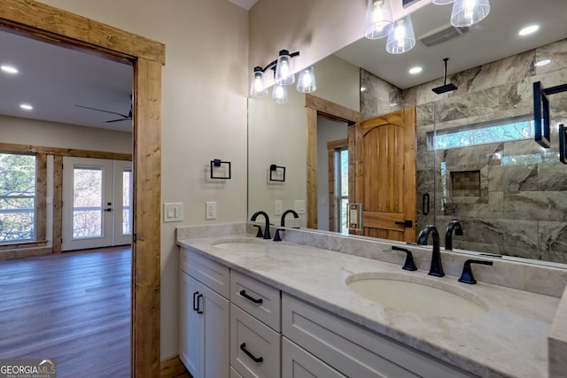 bathroom featuring walk in shower, wood-type flooring, and vanity