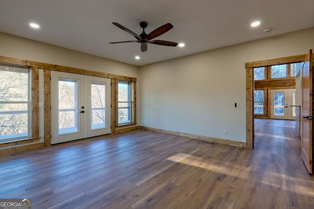 unfurnished room featuring dark hardwood / wood-style flooring, french doors, and ceiling fan