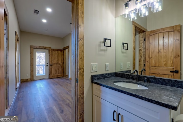 bathroom featuring vanity and wood-type flooring