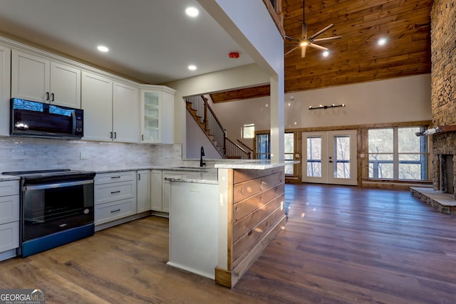 kitchen featuring french doors, dark hardwood / wood-style floors, kitchen peninsula, range with electric cooktop, and white cabinets