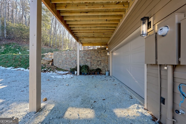 snow covered patio with a garage