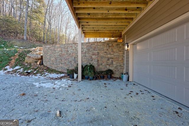 snow covered patio with a garage