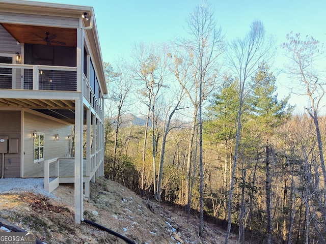 view of property exterior with a balcony and ceiling fan