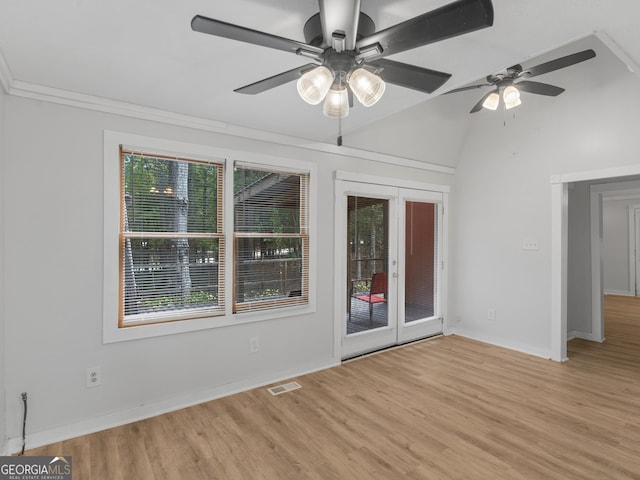 unfurnished room with vaulted ceiling, light hardwood / wood-style floors, french doors, and ceiling fan