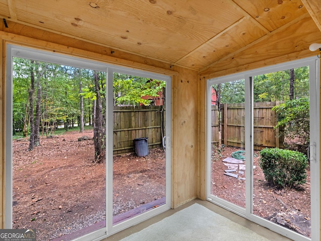 doorway with wood ceiling and vaulted ceiling