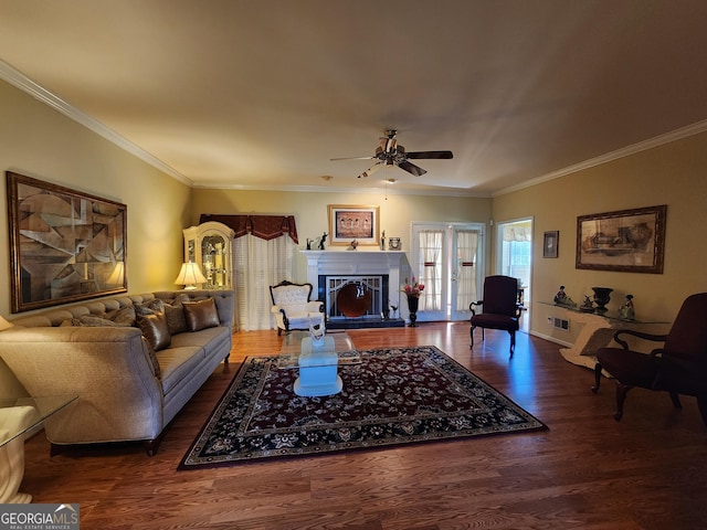 living room with ceiling fan, ornamental molding, and dark hardwood / wood-style flooring