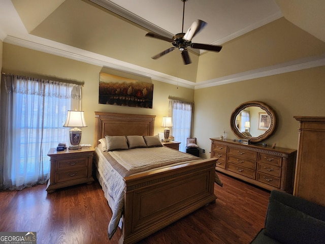 bedroom with crown molding, dark hardwood / wood-style floors, a raised ceiling, and ceiling fan