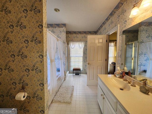 bathroom featuring tile patterned floors, vanity, and a shower