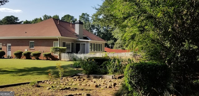 rear view of property with a yard