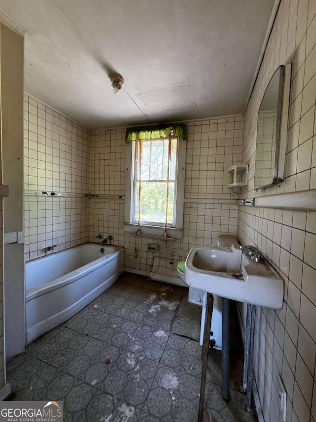 bathroom with tile walls and a tub to relax in