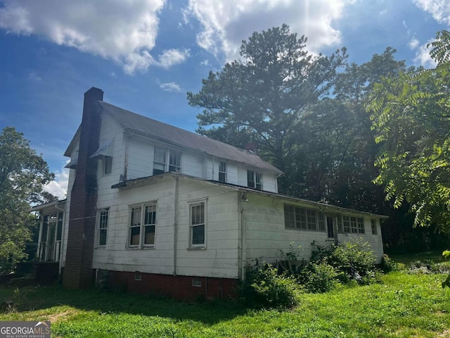 view of side of home featuring a lawn