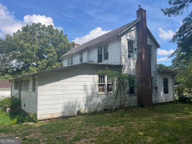 view of side of home featuring a yard