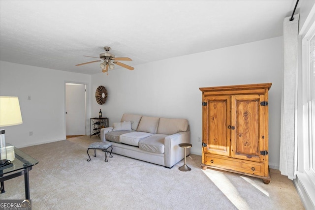 living room featuring light colored carpet and ceiling fan