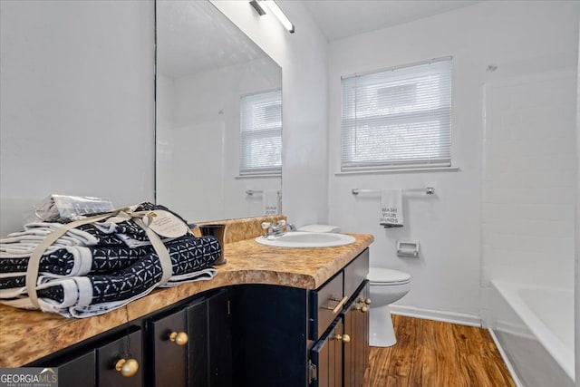 full bathroom with vanity, hardwood / wood-style floors, shower / bathtub combination, and toilet