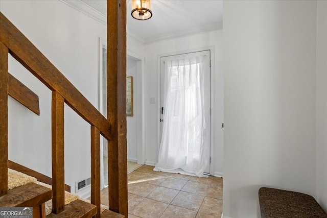 foyer entrance featuring light tile patterned flooring and ornamental molding