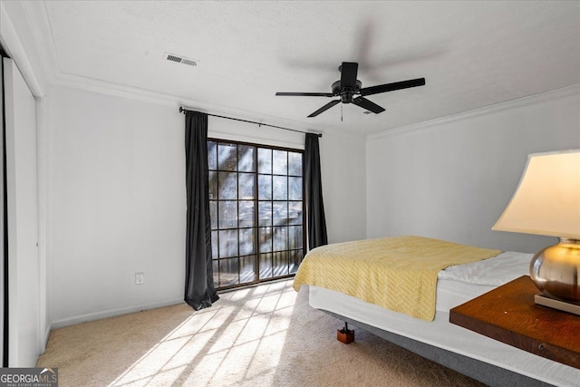 bedroom with crown molding, light carpet, and ceiling fan