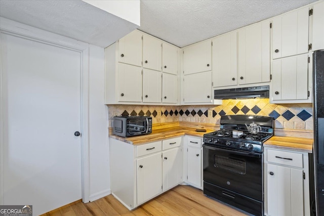 kitchen with white cabinets, light wood-type flooring, and black appliances