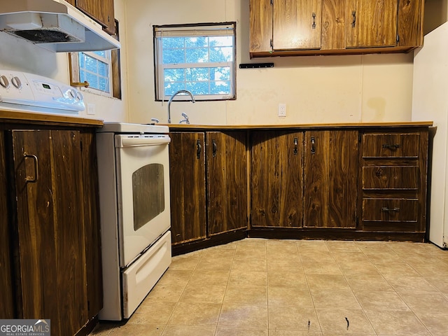 kitchen with light tile patterned flooring and dark brown cabinetry