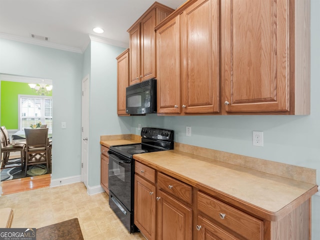 kitchen with crown molding, black appliances, and a chandelier