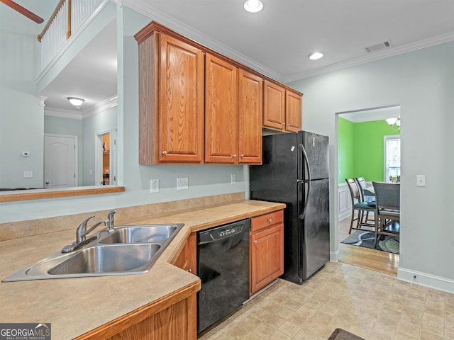 kitchen with sink, crown molding, and black appliances