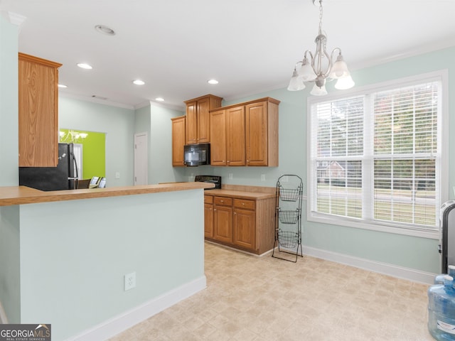 kitchen featuring decorative light fixtures, black appliances, kitchen peninsula, crown molding, and plenty of natural light