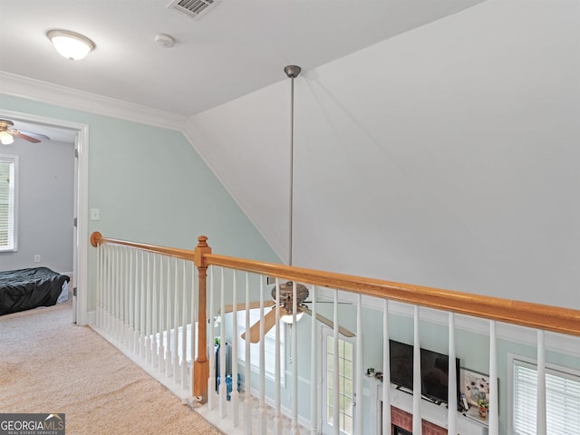 corridor featuring crown molding, lofted ceiling, and carpet floors