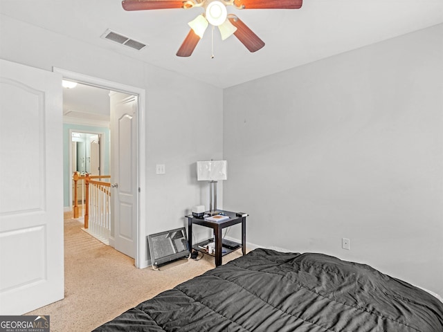 bedroom with ceiling fan and light carpet