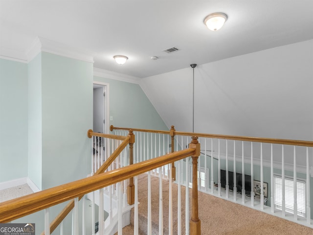 hall featuring crown molding, vaulted ceiling, and carpet