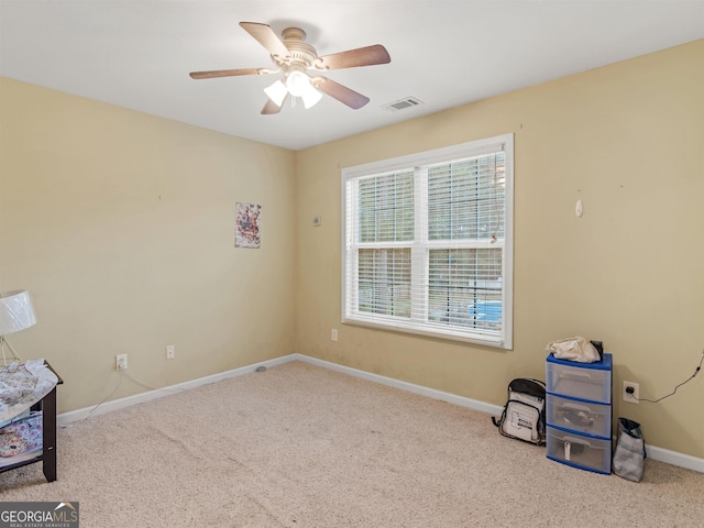 misc room featuring light colored carpet and ceiling fan