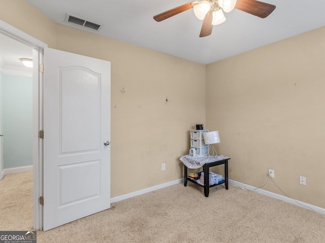 carpeted spare room with ceiling fan