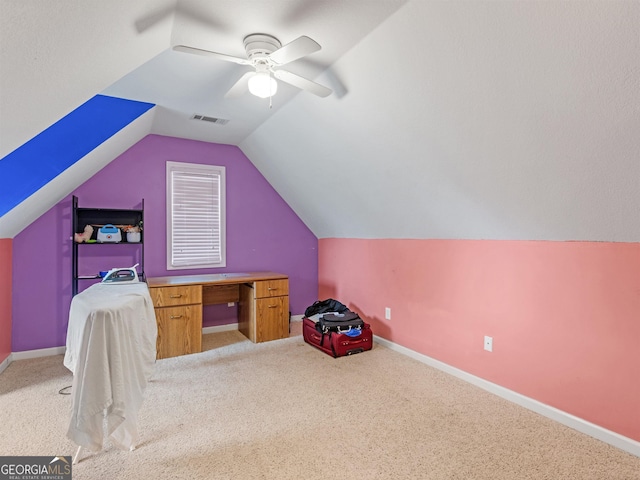 interior space featuring light colored carpet, ceiling fan, and vaulted ceiling