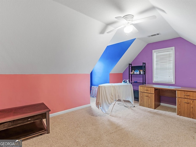 office featuring vaulted ceiling, light colored carpet, and ceiling fan