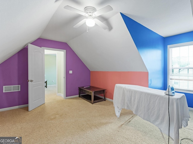 bedroom featuring light carpet, vaulted ceiling, and ceiling fan