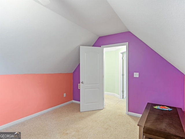 bonus room featuring vaulted ceiling and carpet