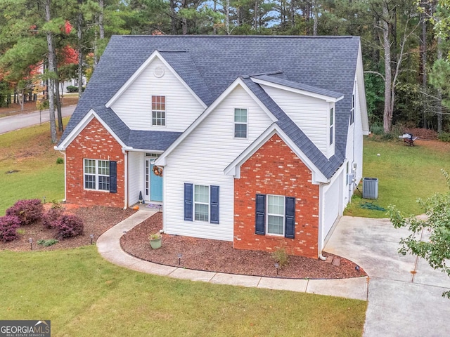 view of property with a garage, central air condition unit, and a front lawn