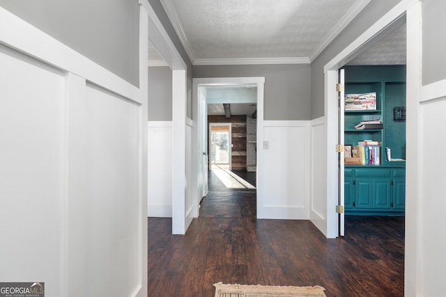 hallway with crown molding, dark hardwood / wood-style flooring, and a textured ceiling