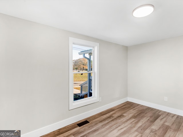 spare room featuring hardwood / wood-style floors