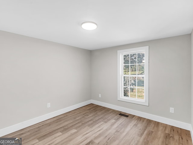 empty room with light hardwood / wood-style flooring