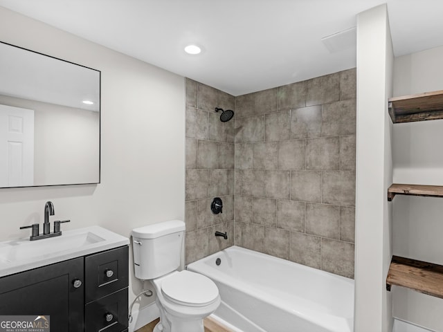 full bathroom with tiled shower / bath combo, vanity, and toilet