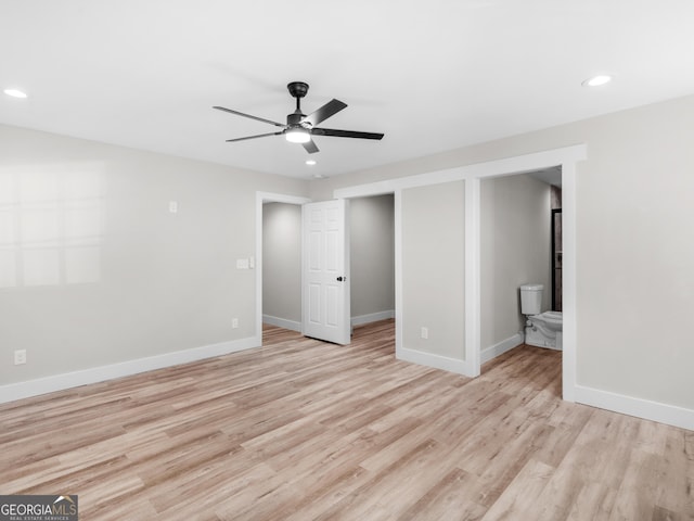 interior space with ensuite bathroom, ceiling fan, and light wood-type flooring