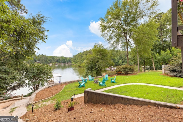 surrounding community featuring a water view and a lawn