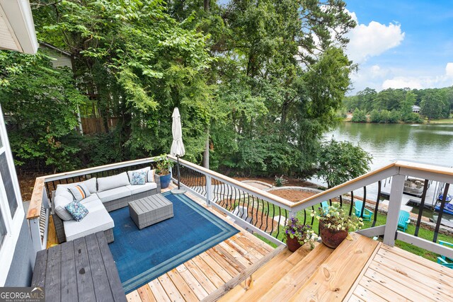 deck featuring outdoor lounge area and a water view