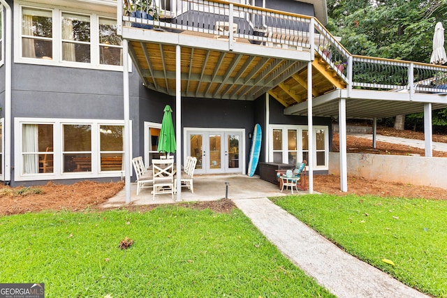 rear view of house featuring french doors, a yard, and a patio area