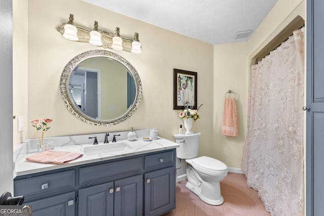 bathroom with vanity, tile patterned flooring, and toilet