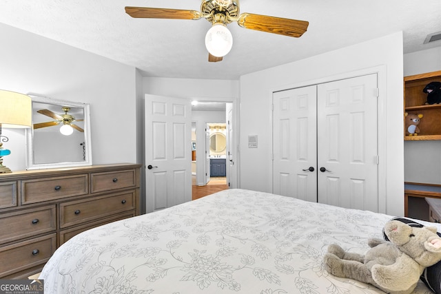 bedroom featuring ceiling fan and a closet