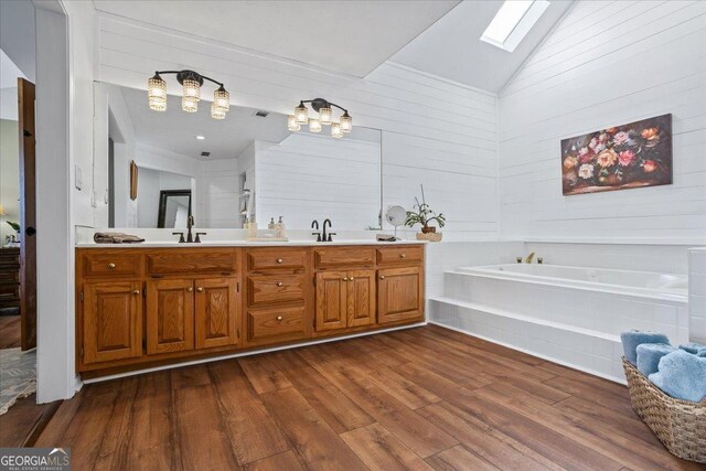 bedroom with hardwood / wood-style flooring, ornamental molding, ceiling fan, and a tray ceiling