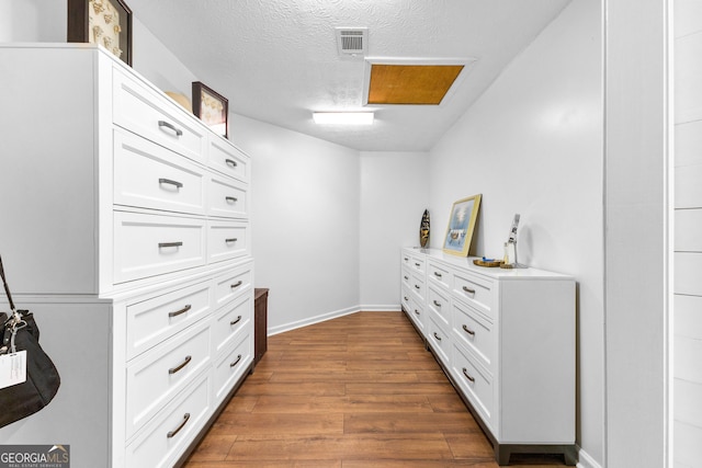 walk in closet featuring dark wood-type flooring